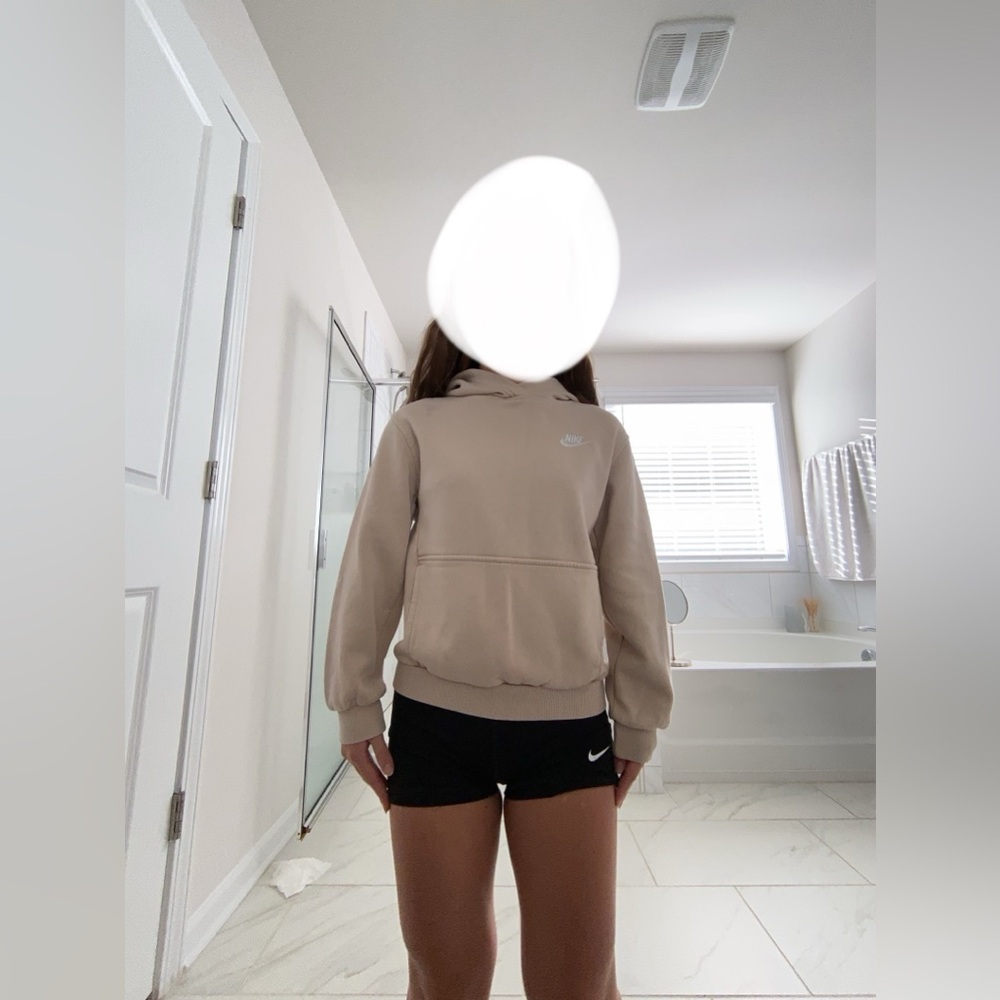 A cream color hoodie from Nike